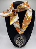 Boho Chic Fall Metal and Wooden Leaf Pendant On An Elegant Orange, Cream, Yellow, and Brown Satin Feel Scarf Necklace-Gift Gor Her